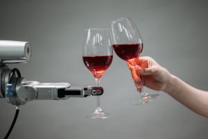 A robot and a human clink wine glasses